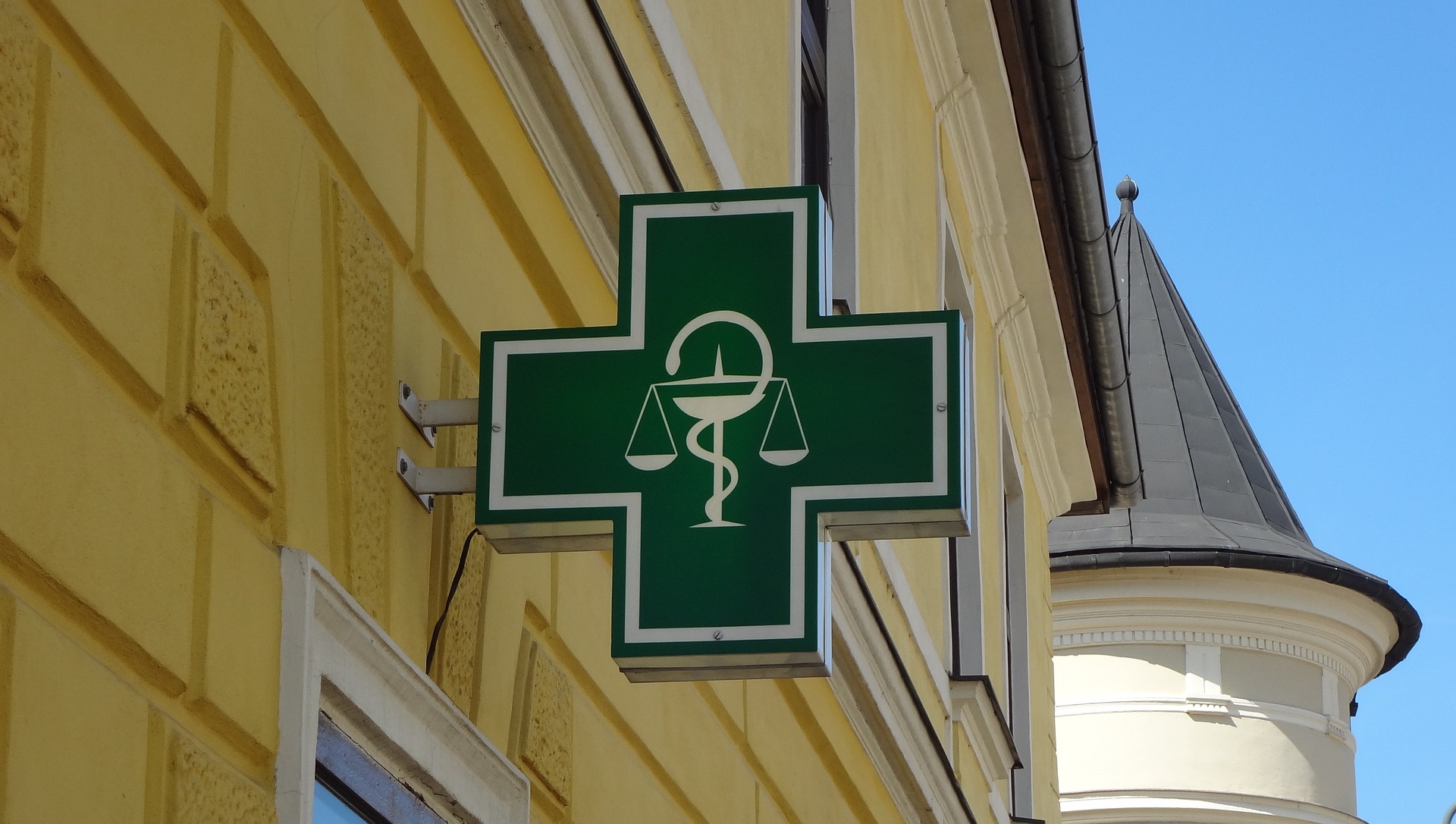 A sign on the outside of a pharmacy